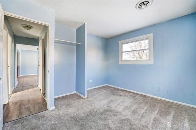 unfurnished bedroom featuring carpet floors and a closet