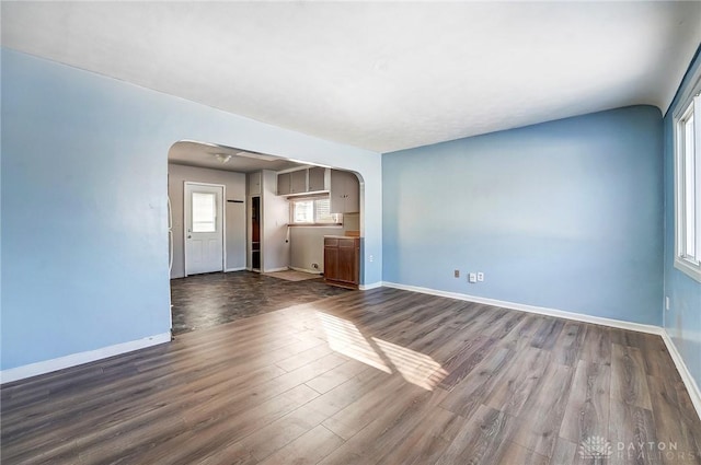 unfurnished living room featuring dark hardwood / wood-style floors