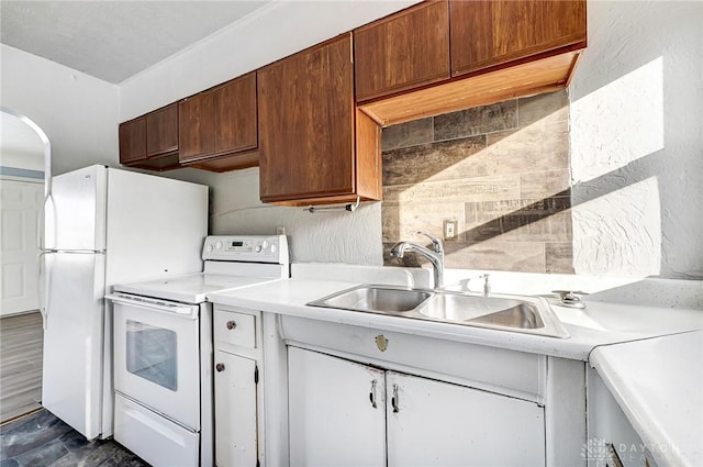 kitchen featuring white appliances, dark hardwood / wood-style flooring, and sink