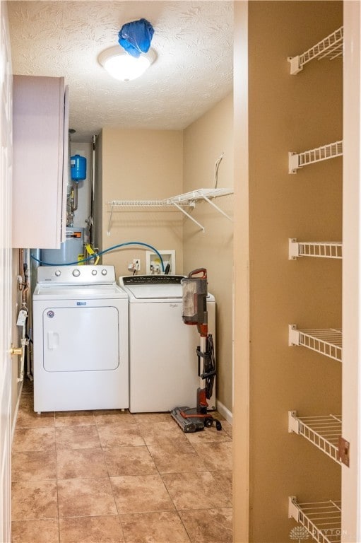 washroom featuring washing machine and clothes dryer and a textured ceiling