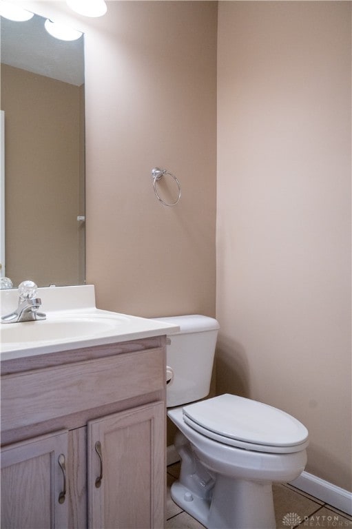 bathroom with tile patterned floors, vanity, and toilet