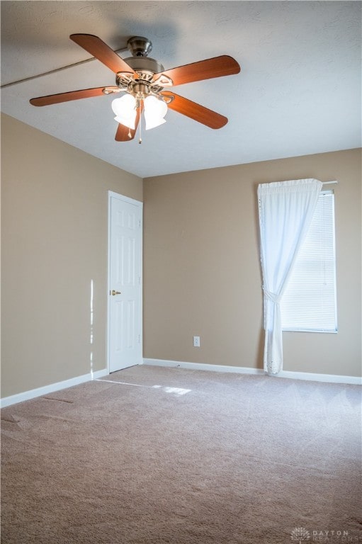 carpeted empty room with ceiling fan