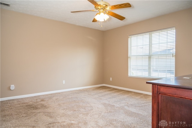 carpeted empty room featuring ceiling fan