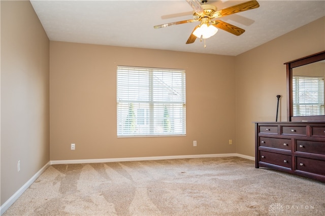 unfurnished bedroom with ceiling fan and light colored carpet