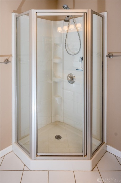 bathroom featuring a shower with door and tile patterned flooring