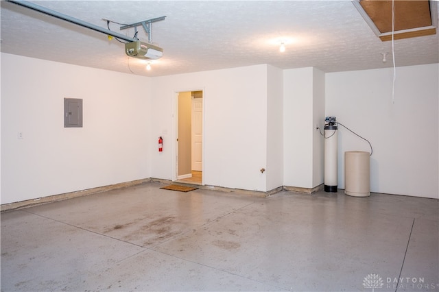 garage featuring electric panel and a garage door opener