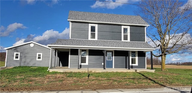 view of front of home featuring a front yard and a porch