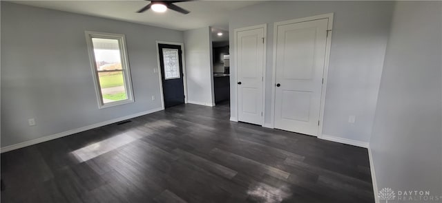 unfurnished room featuring ceiling fan and dark hardwood / wood-style flooring