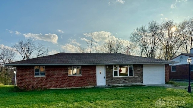 single story home with a front yard and a garage