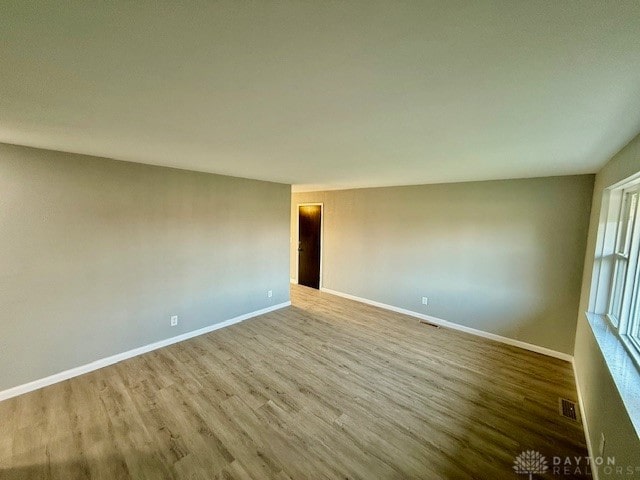 spare room featuring hardwood / wood-style flooring