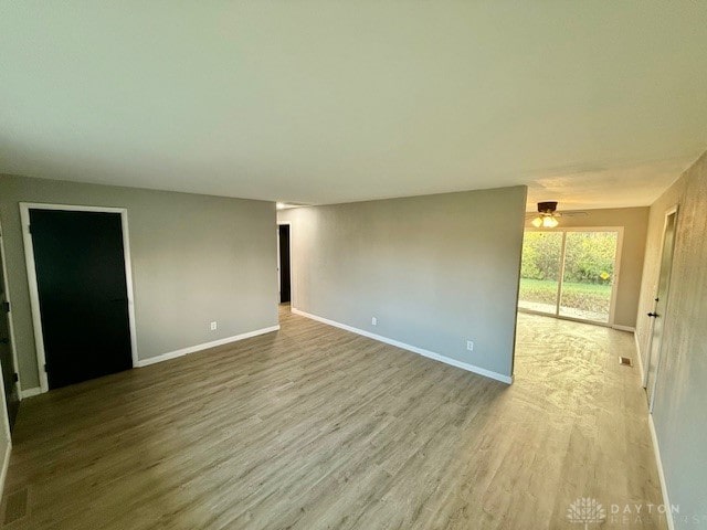 unfurnished room featuring ceiling fan and light hardwood / wood-style floors