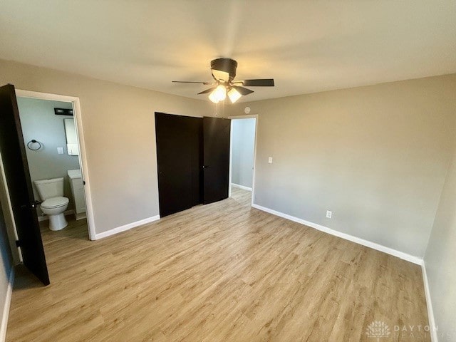 unfurnished bedroom with ceiling fan, light hardwood / wood-style flooring, and ensuite bath