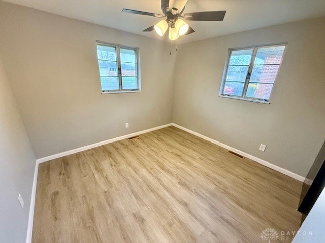 empty room featuring light wood-type flooring and ceiling fan