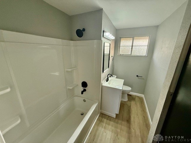 full bathroom with vanity, toilet, wood-type flooring, and shower / tub combination