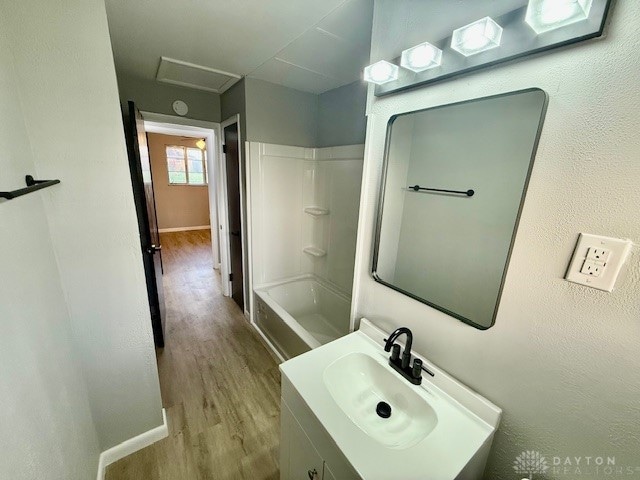 bathroom with shower / tub combination, vanity, and hardwood / wood-style flooring