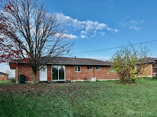 rear view of house with a yard