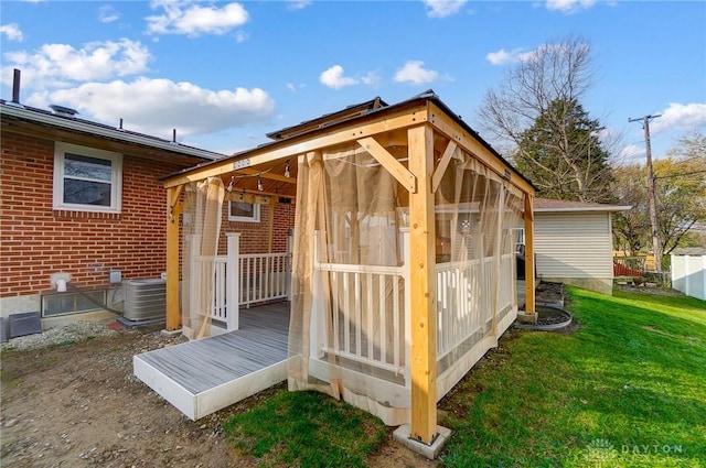 exterior space featuring central AC and a yard