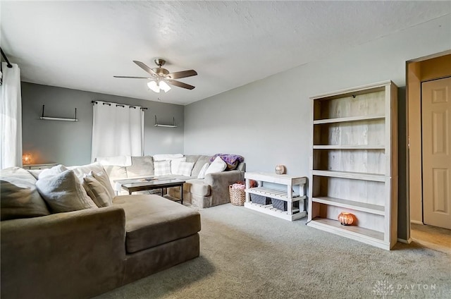 living room featuring ceiling fan, built in features, carpet floors, and a textured ceiling