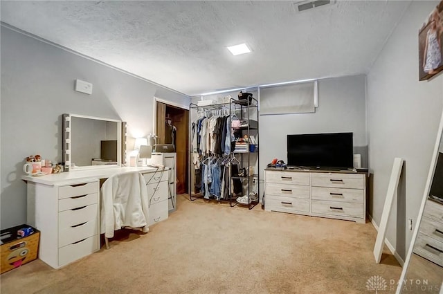 carpeted bedroom featuring a textured ceiling and a closet