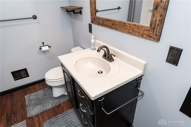 bathroom featuring hardwood / wood-style flooring, vanity, and toilet