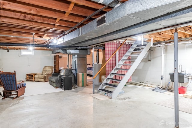 basement featuring sink and gas water heater