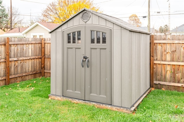 view of outbuilding featuring a lawn