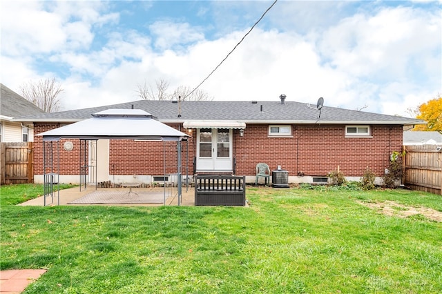 back of property with a gazebo, a yard, cooling unit, and a patio