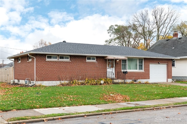 view of front of home with a garage and a front lawn