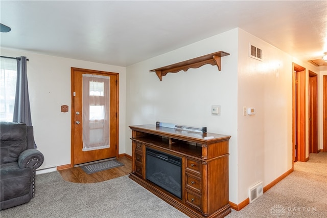 entrance foyer with carpet and a baseboard heating unit