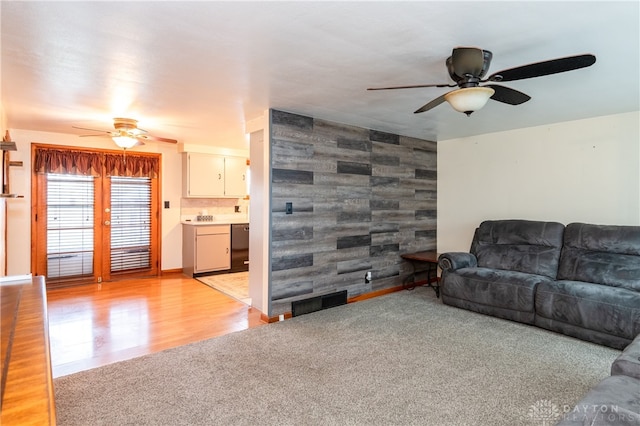 living room featuring light wood-type flooring and ceiling fan