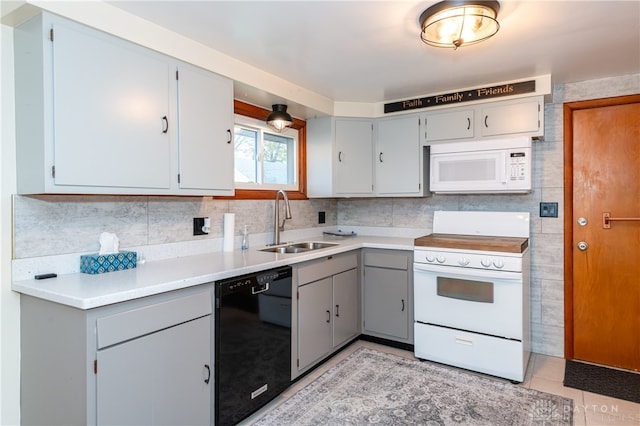 kitchen featuring sink, white appliances, gray cabinets, decorative backsplash, and light tile patterned floors