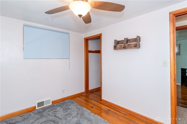 unfurnished room with ceiling fan and hardwood / wood-style flooring