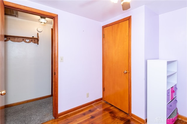 unfurnished bedroom with dark hardwood / wood-style floors and ceiling fan