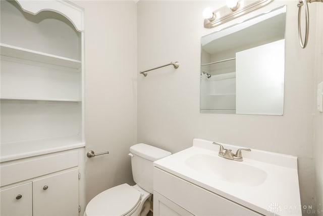 bathroom with vanity, toilet, and walk in shower