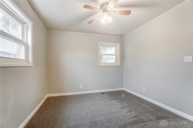 unfurnished room featuring ceiling fan and carpet