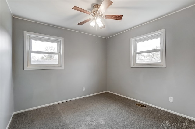 carpeted empty room with plenty of natural light and ceiling fan