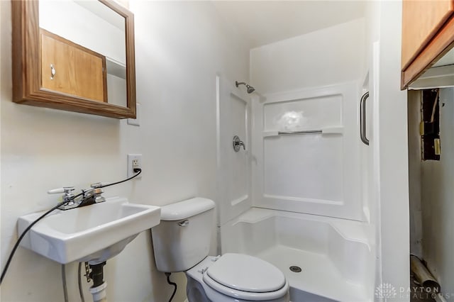 bathroom featuring toilet and walk in shower