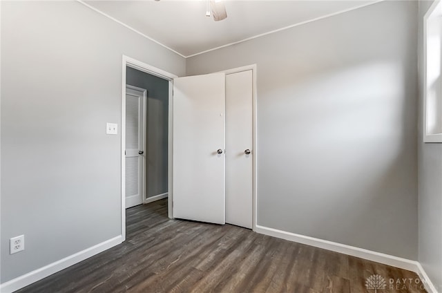 unfurnished bedroom with dark hardwood / wood-style floors and ceiling fan