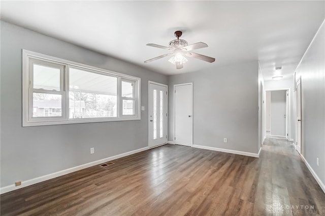 unfurnished room featuring ceiling fan and dark wood-type flooring