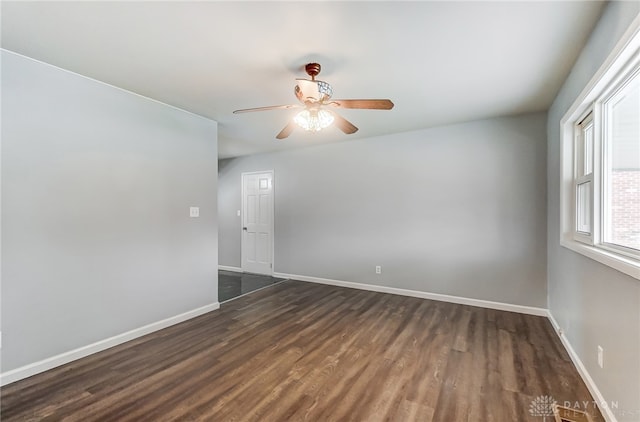 spare room with ceiling fan and dark hardwood / wood-style flooring