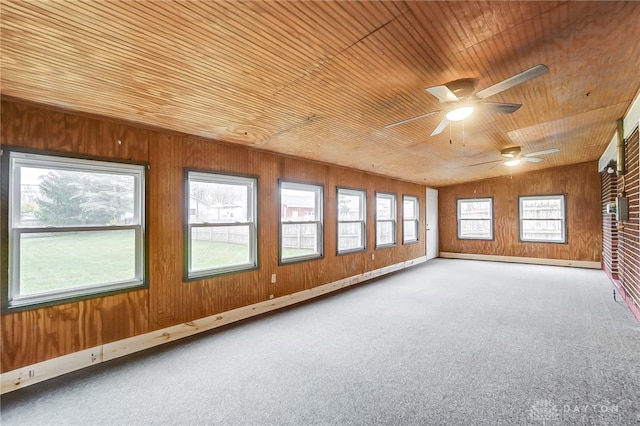 unfurnished sunroom with ceiling fan and wood ceiling