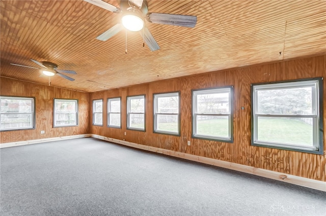 unfurnished room featuring wood walls, wooden ceiling, and vaulted ceiling