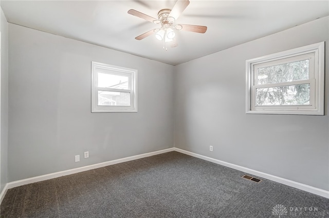 carpeted empty room featuring ceiling fan