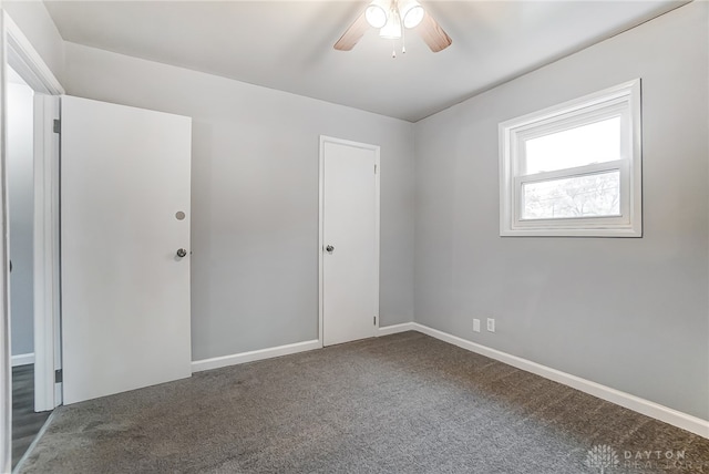 unfurnished room with ceiling fan and carpet floors