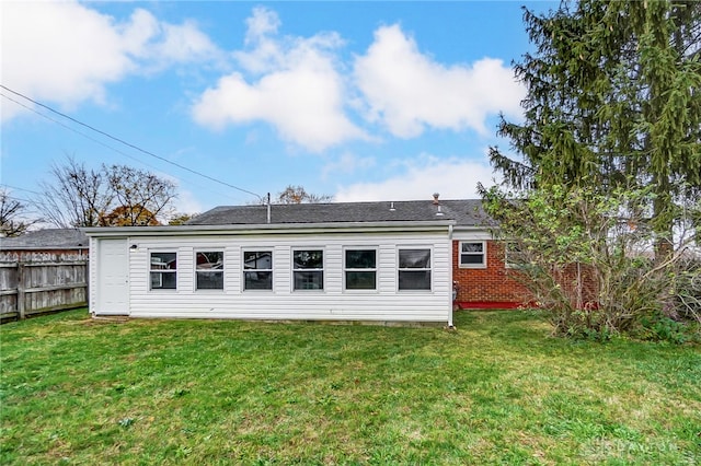 back of house with a lawn