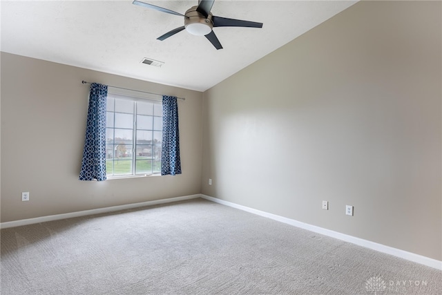 carpeted spare room with ceiling fan and lofted ceiling