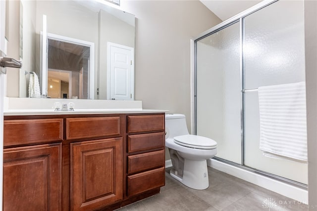 bathroom with tile patterned floors, vanity, toilet, and walk in shower