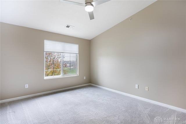 spare room with carpet floors, vaulted ceiling, and ceiling fan