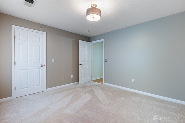 unfurnished bedroom with light colored carpet