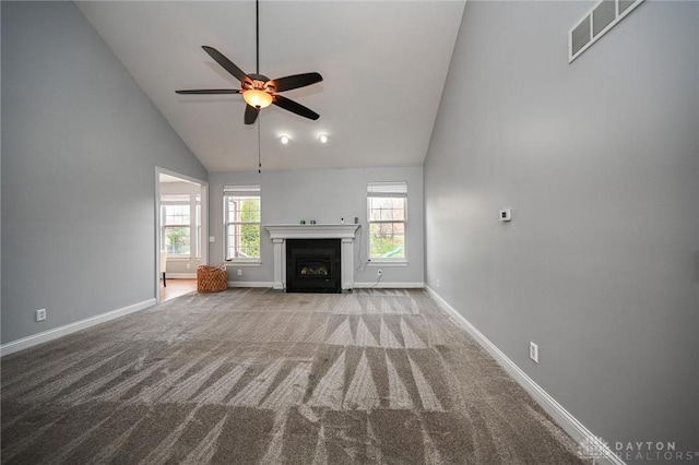 unfurnished living room featuring carpet floors, a wealth of natural light, and high vaulted ceiling